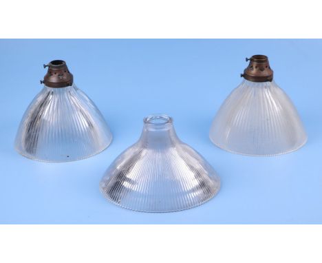 Two Holophane moulded glass ceiling lights with brass fittings, 21cms diameter; together with a similar ceiling light, 22.5cm