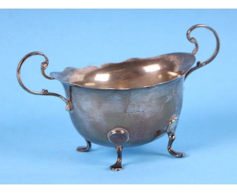 An Edwardian silver sucrier with two-scroll handles and hoof feet, 115g, Birmingham 1903.