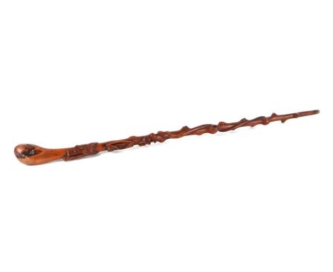 An Irish carved yew wood walking stick, the shaft carved with shamrock, harp, coiled adder and castle, 92cms long.Condition R