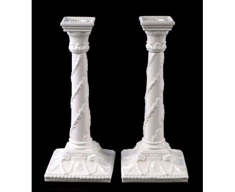 A pair of Royal Worcester porcelain candlesticks, 27cms high (2).