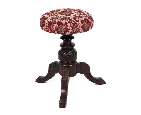 An Edwardian carved oak tripod piano stool with carved acanthus leaf legs, 32cms diameter.