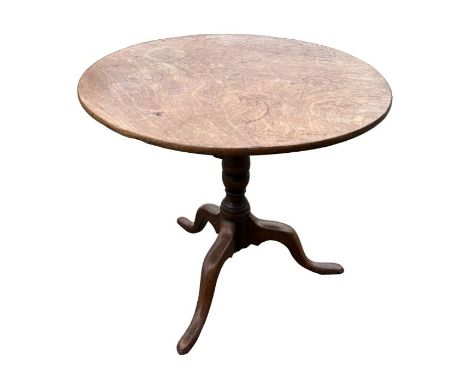 A 19th century elm tripod table with turned column terminating on a tripod base with slipper feet, 87cms diameter.