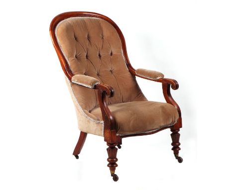 A Victorian walnut upholstered button back open armchair with scroll arms and baluster reeded front legs.