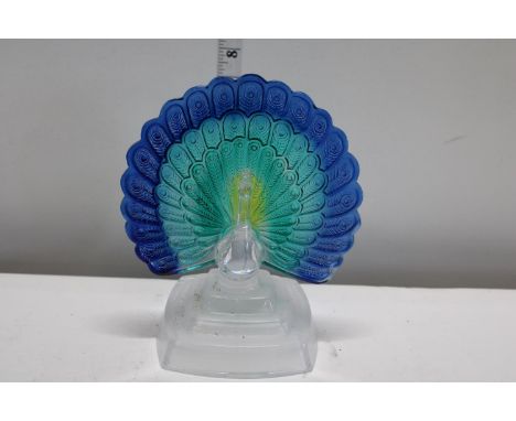 A vintage glass peacock on stand 
