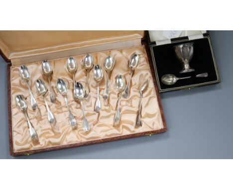 A cased set of twelve French white metal coffee spoons and a cased silver egg cup &amp; spoon.