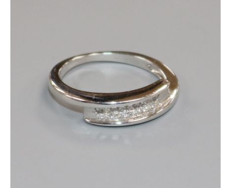 A white metal and eighteen stone diamond twin row dress ring, size J.