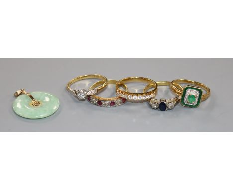 Five assorted 18ct gold and gem set rings including ruby and diamond half hoop and emerald and enamel and a jadeite pendant.