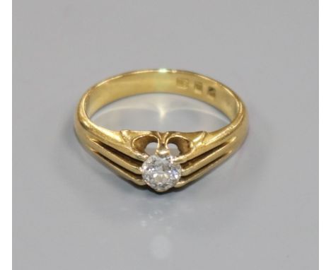 A 1930's 18ct gold and claw set solitaire diamond ring, size K.