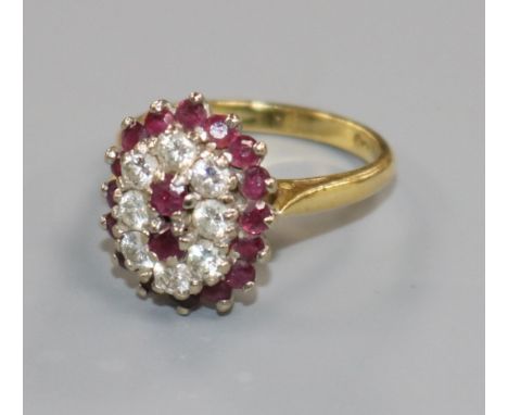 An 18ct gold, ruby and diamond cluster dress ring, size M/N.