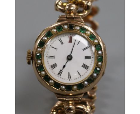 An early 20th century 9ct gold gem set manual wind wrist watch on a 9ct gold expanding bracelet.