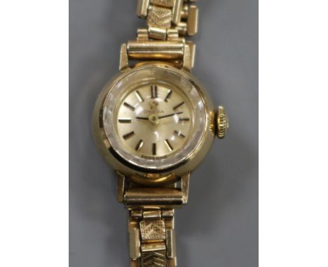 A lady's 9ct gold Omega manual wind wrist watch, on a steel and gold plated bracelet, with Omega box.