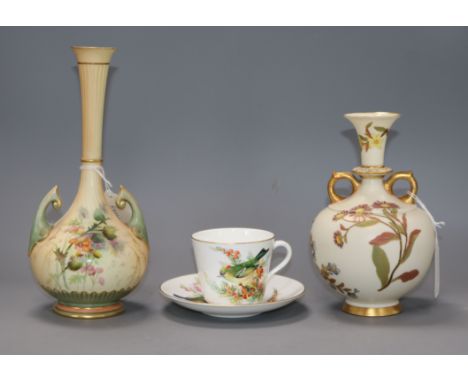 A Royal Worcester blush ivory vase, an ivory ground vase, and a Worcester China Decorator's bird painted cup and saucer talle