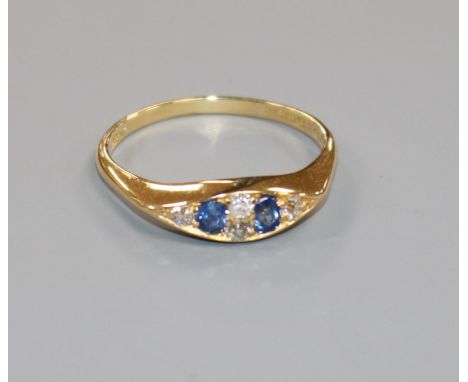 An Edwardian 18ct gold, sapphire and diamond six stone ring, size V.