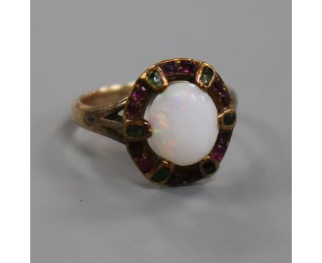 An early 20th century yellow metal, white opal and gem set ring in the "suffragette" colours, size N.