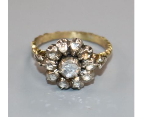 A 19th century yellow metal and rose cut diamond set cluster ring, with carved shank, size L.