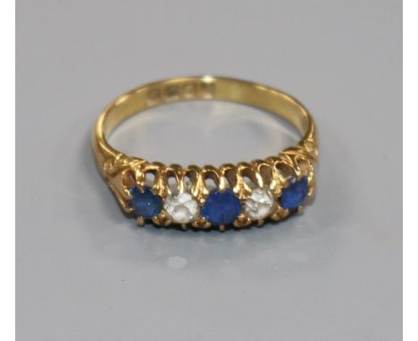 An Edwardian 18ct gold, sapphire and diamond five stone half hoop ring, size M.