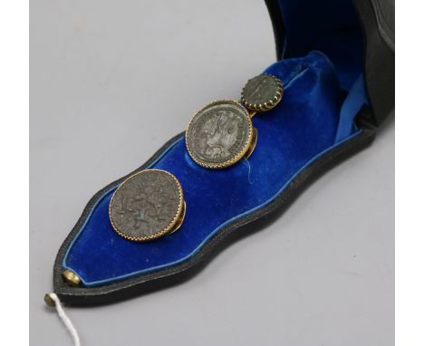 Three Roman coins, yellow metal mounted as a tie pin and button set, in French fitted box.