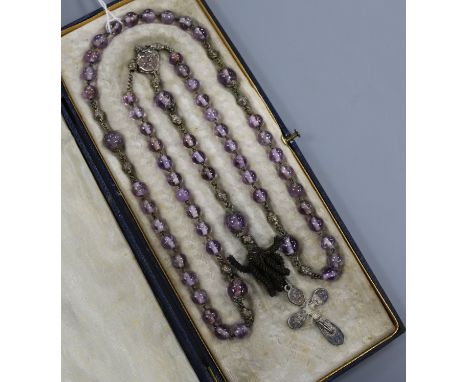 An early 20th French amethyst bead necklace, with white metal cross pendant drop, approx. 90cm.