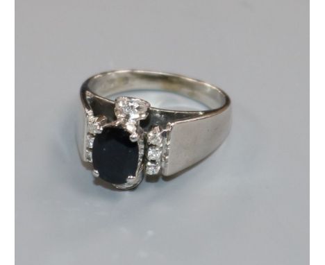 A modern white metal, sapphire and diamond set dress ring, size L.