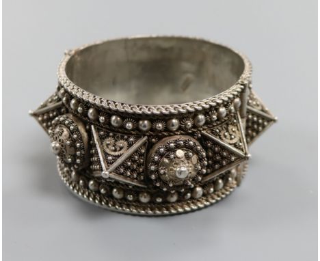 A large Lebanese white metal hinged bangle.