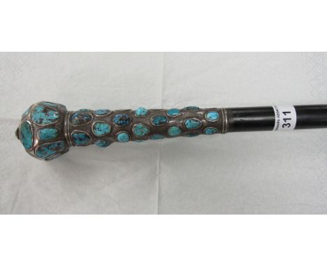 A Continental Walking Stick the white metal handle inset with turquoise and carved jadeite scarab. (Provenance: reputedly bel