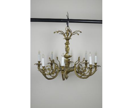 A gilt metal eight branch Chandelier with petal shaped sconces and figural column