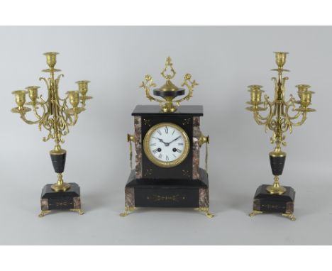 A late Victorian Clock Garniture, the clock with white enamel circular dial, 8-day movement in black slate case, with pair of