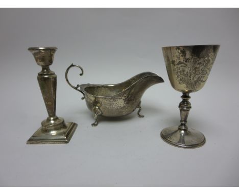 A 1972 Hereford Cider Festival Goblet, a George V Sauce Boat, Chester 1918 and a Candlestick on square base, Chester 1920