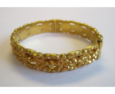 An intricate pierced and embossed Indian gold hinged Bangle