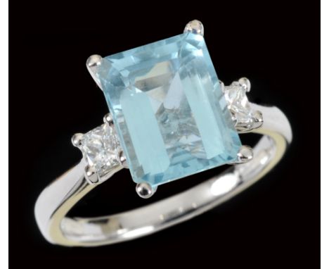 An Aquamarine and Diamond three stone Ring corner claw-set step-cut aquamarine, 3.15cts, between two princess-cut diamonds in