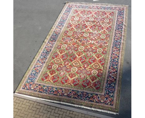 A large Turkey Carpet multi bordered with central diamond lozenge shapes with allegorical, animal figure designs on principal