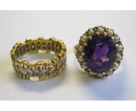 An Amethyst and Seed Pearl Cluster Ring claw-set oval-cut amethyst within seed pearl frame in 9ct gold, ring size L and a tre