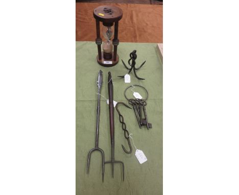 An early polished steel Bread Fork with scratch design, another with baluster wooden handle, a large wooden framed Egg Timer,