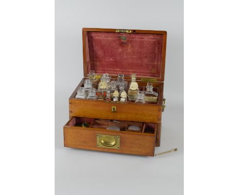 A 19th Century mahogany Apothecary Cabinet with hinged cover revealing bottles in compartments, fitted drawer to base contain