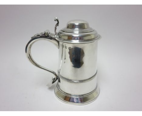 A George III silver Quart Tankard with domed lid having volute thumb piece, scroll handle with heart shape finial, London 176