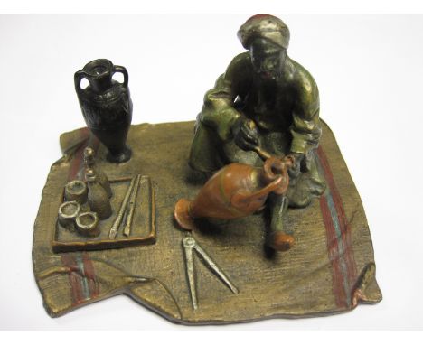 A cold painted bronze Model of an Eastern Potter, 4in