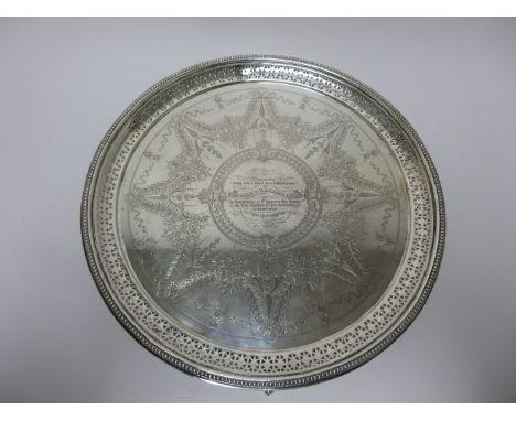 A Victorian silver circular Salver with presentation inscription, floral swag engraved, pierced and beaded rim on scroll feet