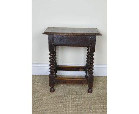 An antique oak Joint Stool on bobbin turned and square supports with square stretchers, 18in
