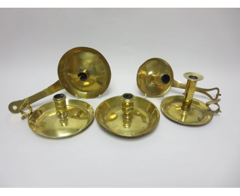 An 18th Century brass Chamber Candlestick with one piece base and handle having pierced heart, another with flat section hand