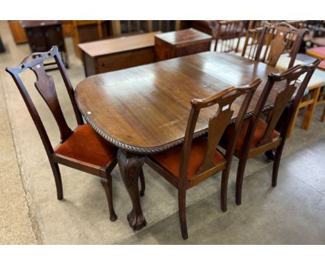 An Edward VII Chippendale Revival carved mahogany extending dining table and four chairs 