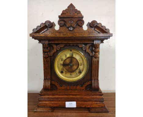 A early 20th Century American Ansonia carved oak mantel clock 