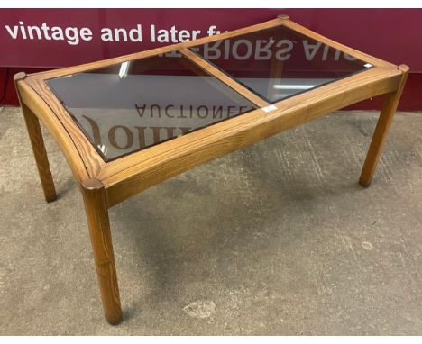 An Ercol Golden Dawn elm and glass topped coffee table 