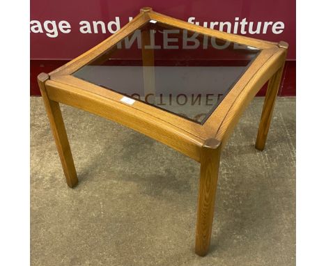 An Ercol Golden Dawn elm and glass topped coffee table 