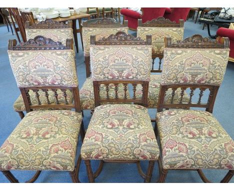 A set of six late Victorian oak dining chairs with H framed stretchers and tapestry seats
