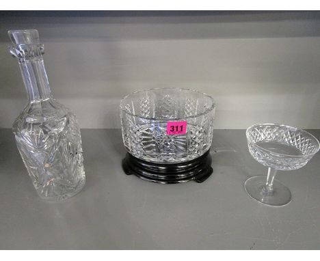 A Waterford cut glass bowl on a black glass stand and a Waterford pedestal glass and a cut glass decanter