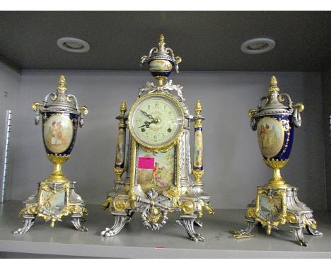 A reproduction French style mantle clock and two matching garnitures