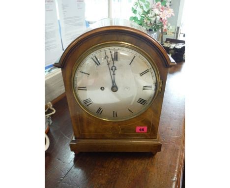 An Edwardian string inlaid mahogany mantle clock with a silvered Roman dial