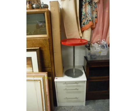 A modern Italian red plastic and chrome pedestal table, 22 high, 16 diameter, a melamine three drawer bedside cabinet, 22 hig