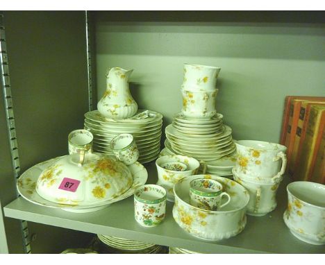A Limoges part breakfast set with floral decoration on a white background, together with Copeland Spode coffee cans and sauce