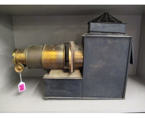 A Cinema Traders Ltd black painted metal and lacquered brass magic lantern with a detachable top, side inspection door and hi